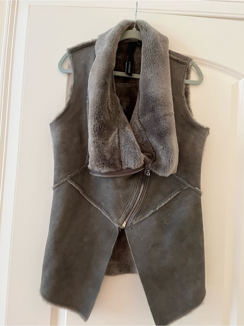 Shearling Vest in grey color with natural lamb fur inside. Zipper up or relaxed.